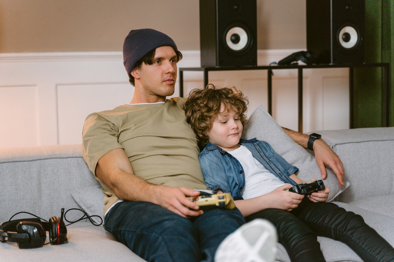 A father playing video games with his son